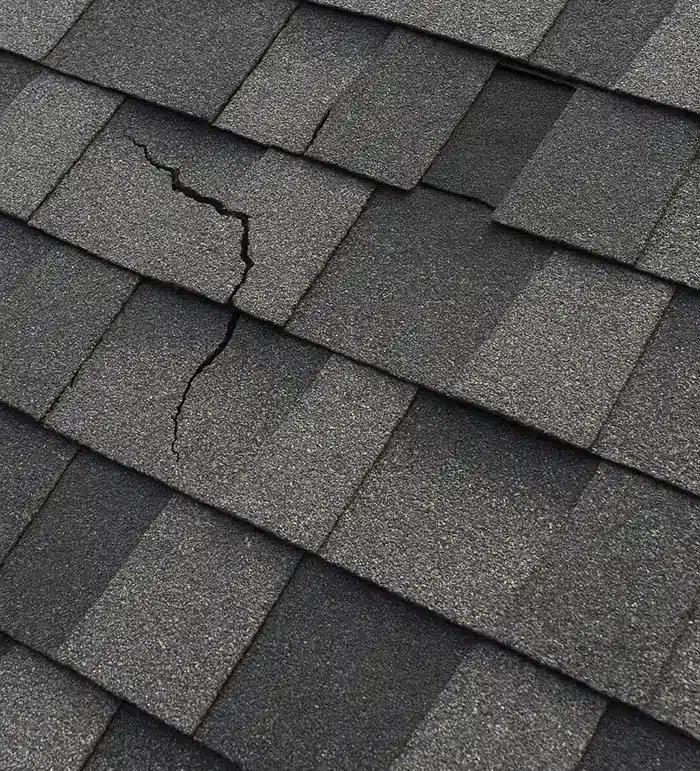 Newly installed roof with visibly damaged and missing shingles

